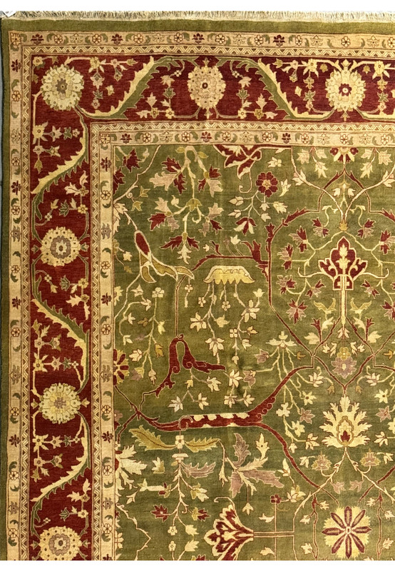 Close-up of a 10x15 Oriental Chobi Peshawar rug showcasing deep burgundy and olive green floral designs with intricate borders