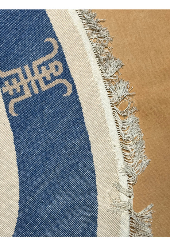 Corner detail of a 4x6 oval silk rug, emphasizing the traditional Asian longevity symbol against the deep blue background and the back of the rug highlighting the high quality weave of this 4x6 art deco oval rug