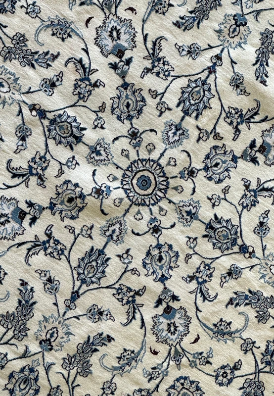 Close-up of the intricate silk and wool blend in a Persian Nain rug.