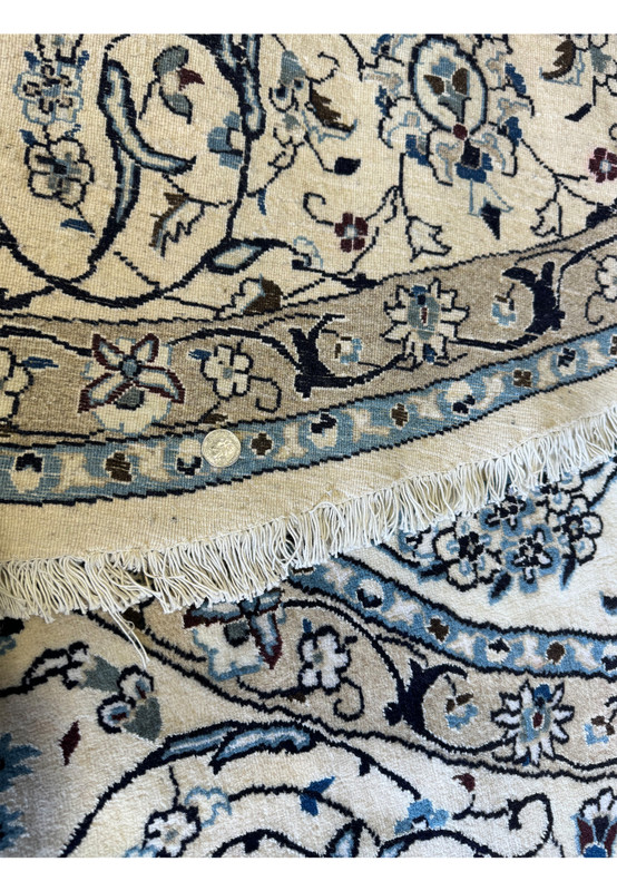 Angled shot of the Persian Nain Round Rug highlighting the weave and plush texture