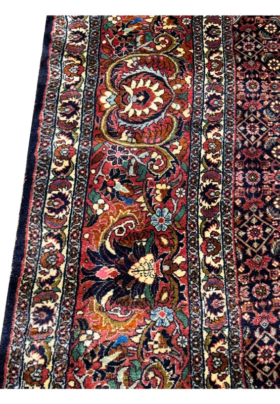 Angled shot illustrating the plush pile of the Persian Bijar rug with a focus on the layered floral and geometric designs