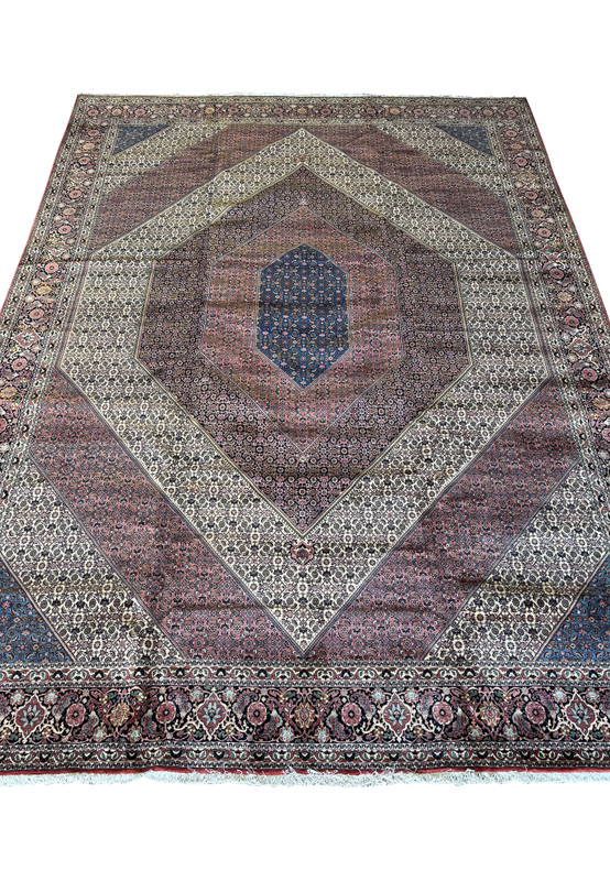 Detailed perspective of the Persian Bijar rug's ornate border and fringe, highlighting the quality of the weave and vibrancy of colors.