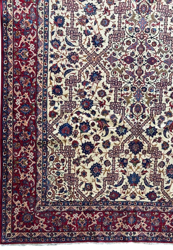 Close-up of the rug's corner, showcasing the intersection of the central field and the border's elaborate design.