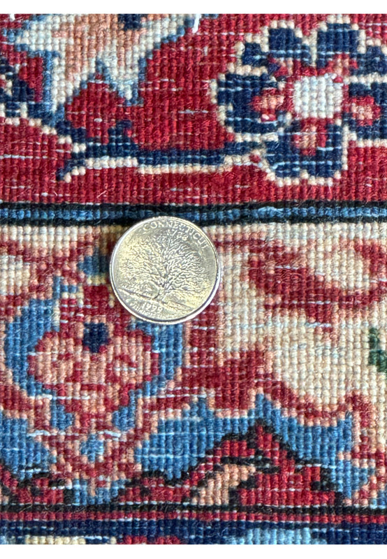 Diagonal view of a 10'7 x 14'7 Persian Isfahan Wool & Silk Rug, focusing on the transition from the central field to the border design.