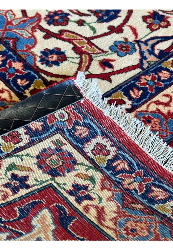 Macro view of a 10'7 x 14'7 Persian Isfahan Wool & Silk Rug, showing the fine weave density with a coin for scale.
