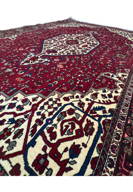 Angle shot of the Persian Qum Kork rug, focusing on the plush texture and the exquisite border design that complements the central field