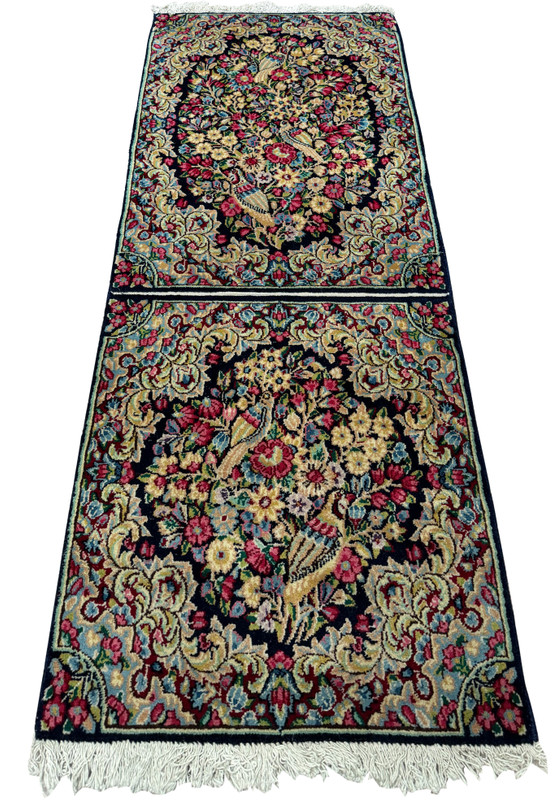 Top view of the Persian Kerman rug's elaborate floral design and dual-rug weaving technique."