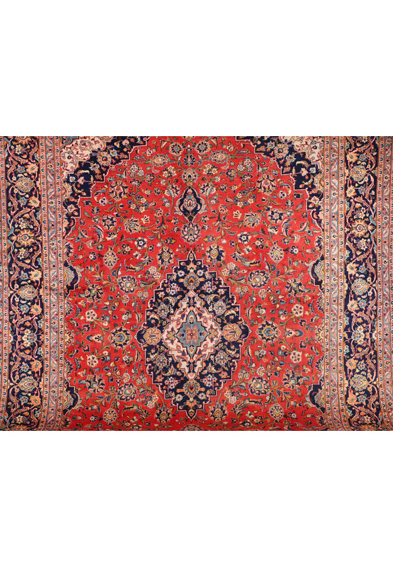 A close-up of the central part of the Persian Kashan rug, showcasing the detailed design and color variations within the central medallion and surrounding floral motifs.