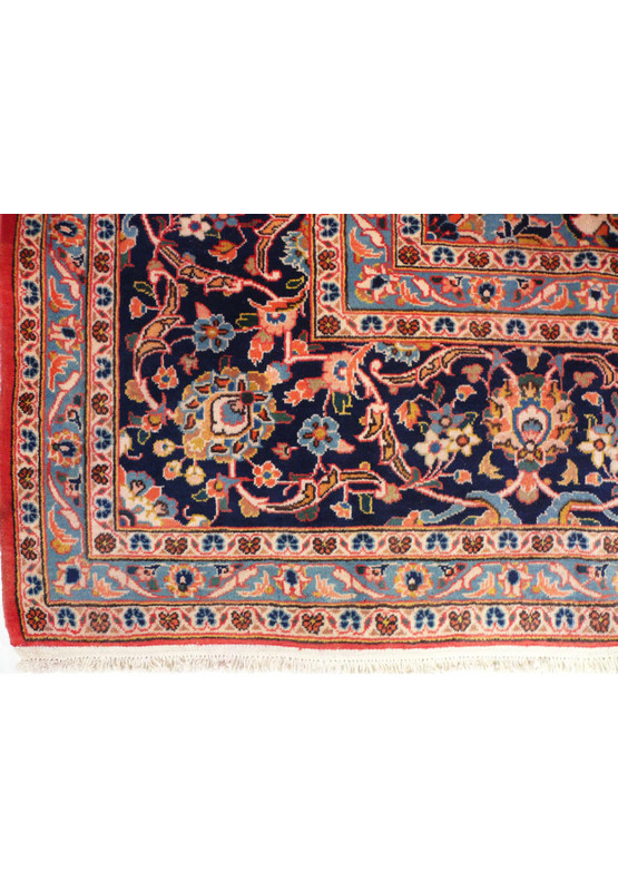A close-up of the rug's fringe, showing the natural wool color and the quality of the finishing at the ends of the rug.