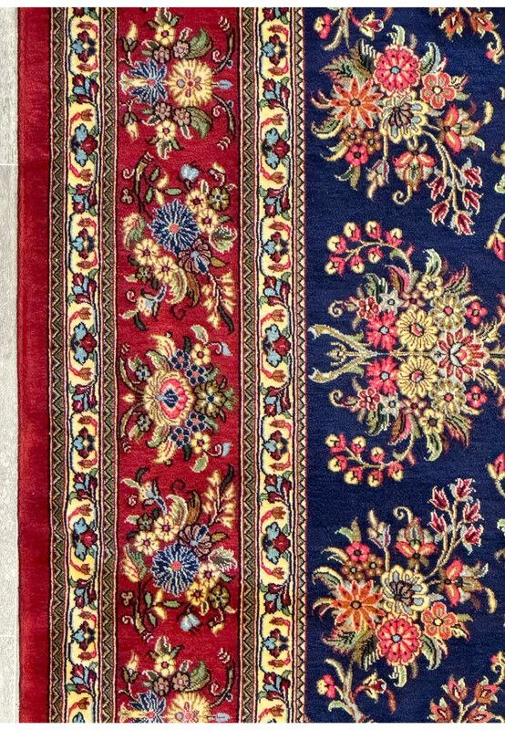 Microscopic detail of the Persian Qum Kork rug's fabric weave, illustrating the intricate silk and Kork wool fibers intertwined in rich, decorative patterns.