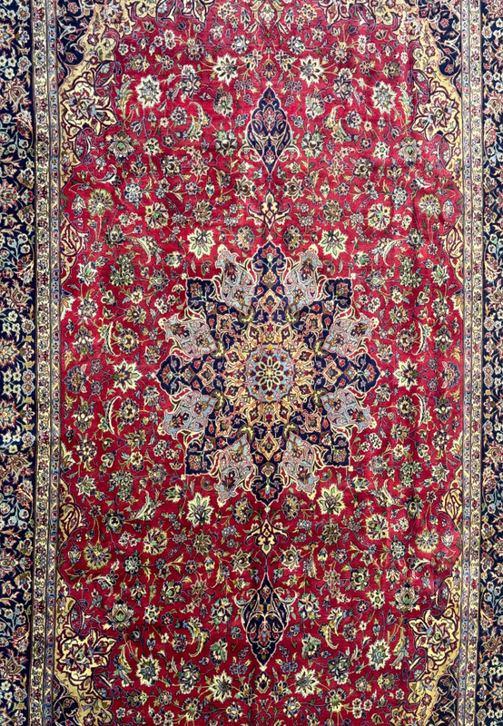 Central medallion of Persian Isfahan rug - Image centered on the elaborate central medallion of the Persian Isfahan rug, illustrating the detailed designs and vibrant color palette.