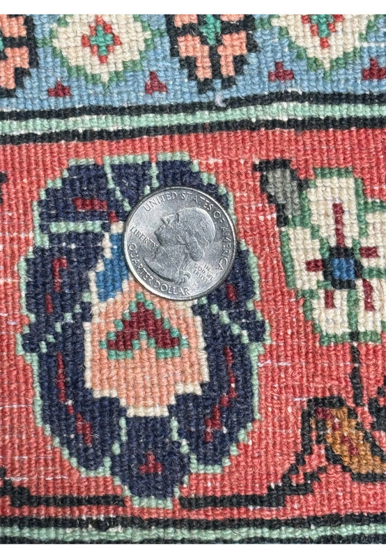 Side view of the Persian Bidjar Rug rolled up, emphasizing the thickness and quality of the wool used in its construction.