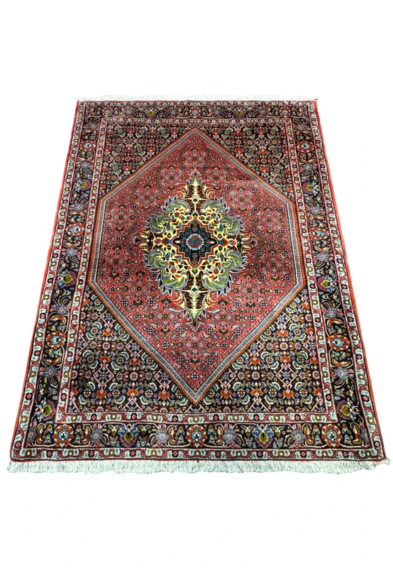 An angled perspective of the Persian Bidjar rug, emphasizing the central medallion's vibrant colors and intricate design. The surrounding field and border patterns are also visible, showcasing the rug's elaborate details.