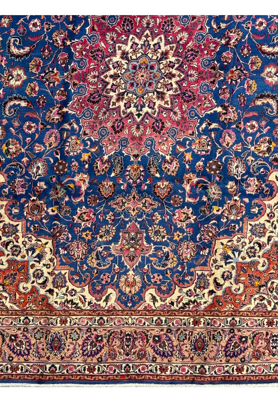 Lower section of a Persian Mashad Rug, showcasing intricate floral motifs and a richly patterned border