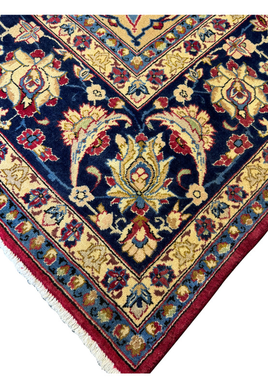 Close-up of the corner detailing on a Persian Isfahan rug, showcasing the intricate design and vibrant colors