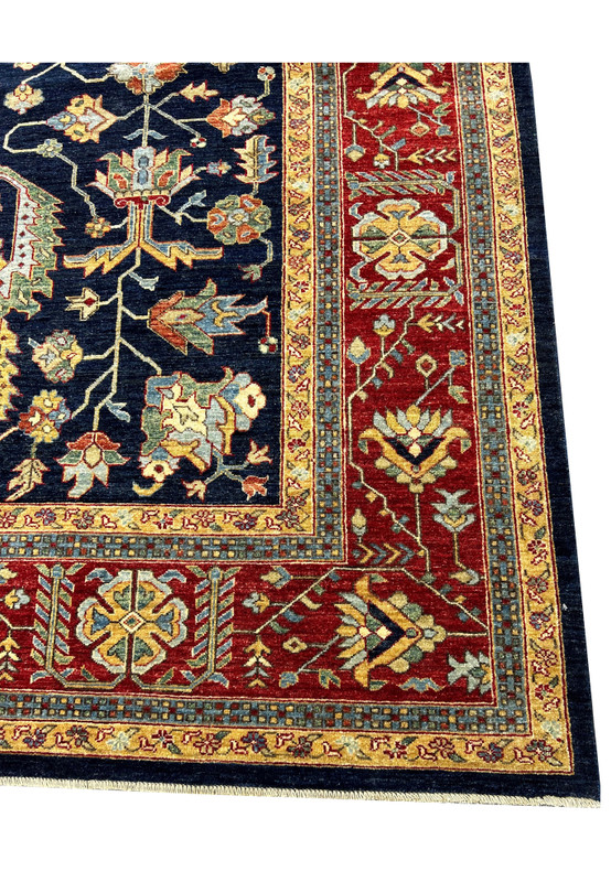 Corner detail of a handmade Ziegler rug with deep red borders, showcasing detailed craftsmanship and intricate floral motifs.