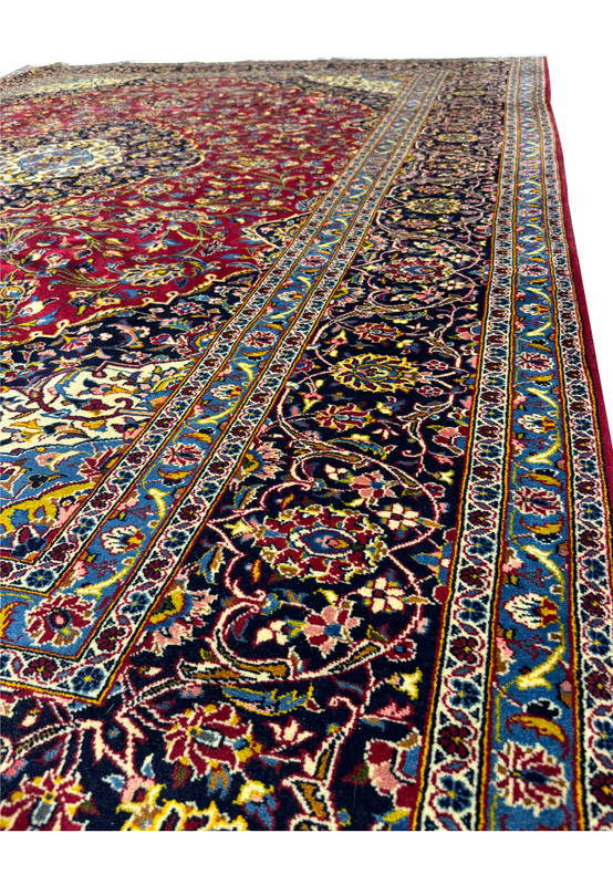Side perspective of a Persian Kashan Rug, showcasing the detailed border and vibrant color palette.