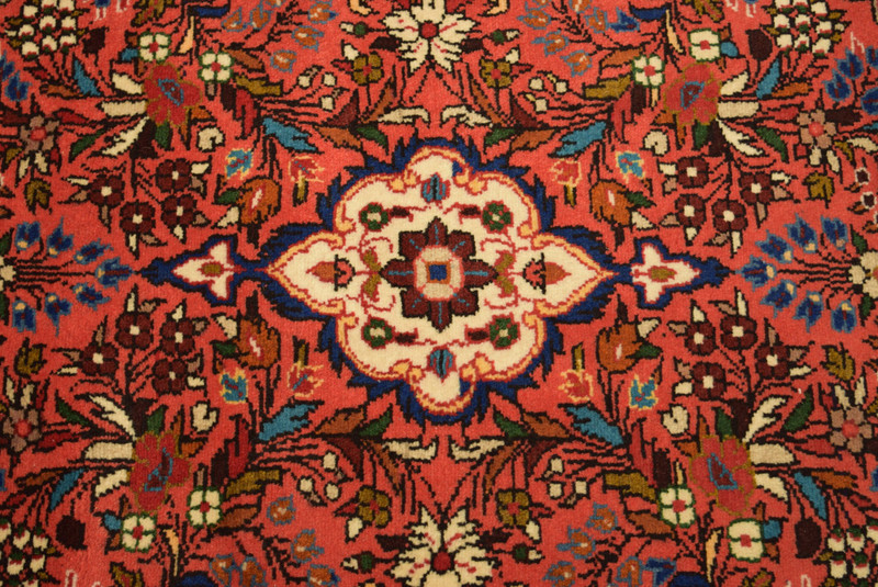 3x10 Persian Rudbar Runner rug center medallion zoomed in emphasizing dark pink and ivory medallion