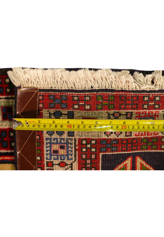 Detail of the backside of 2'7 x 9'6 Persian Yalameh Runner Rug with a ruler to illustrate the density of the weave.