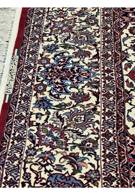 Close-up of border floral motifs and signature of Seirafian on Persian Isfahan Silk Rug.