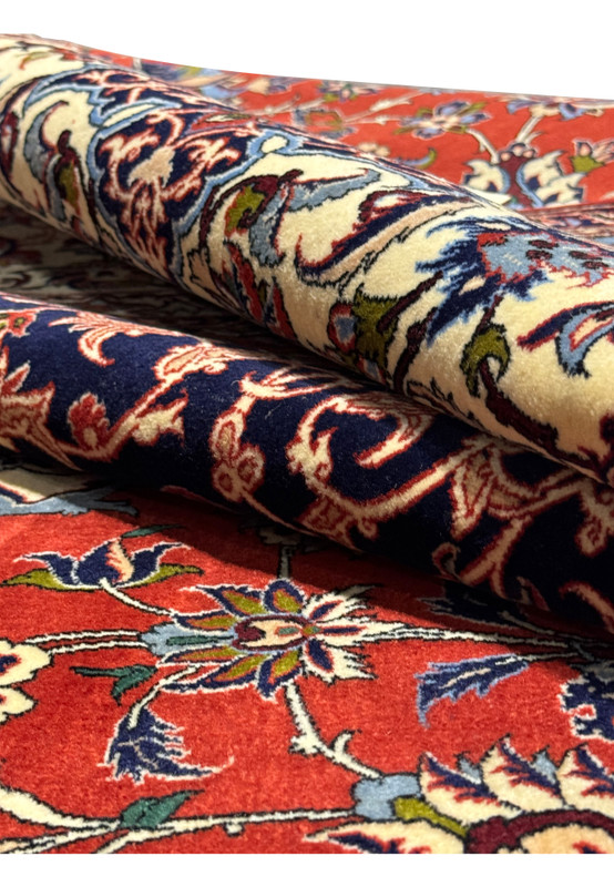 Rolled view of Persian Isfahan Silk Rug showcasing the vibrant colors and intricate design.