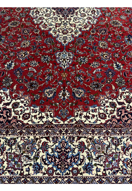 Detailed view of the red and ivory floral motifs in Persian Isfahan Silk Rug.