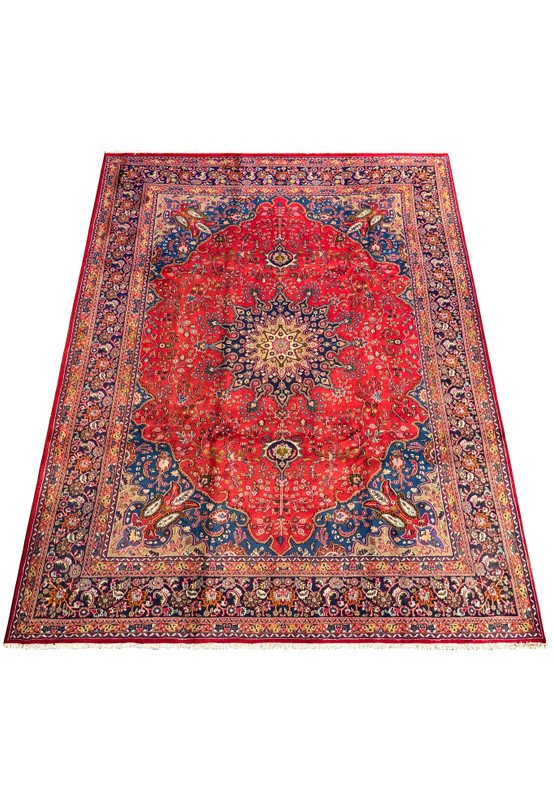 Angled view of the Persian Mashad rug highlighting its detailed border and floral motifs.