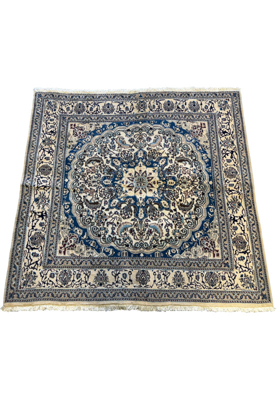 Angled view of the Persian Nain Square Rug showcasing its detailed border and central design.