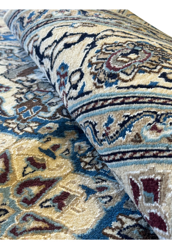 Rolled edge view of the Persian Nain Square Rug, displaying its thickness and weave quality.