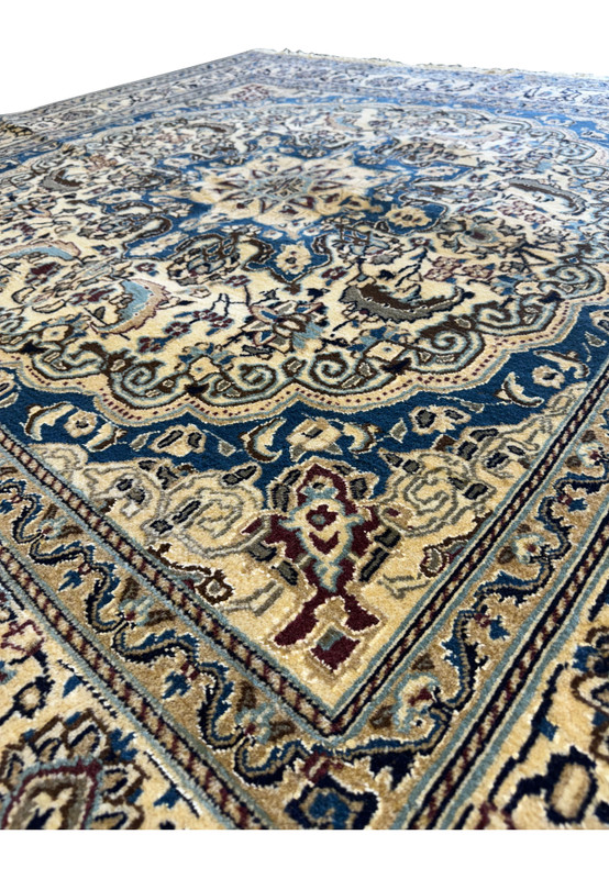 Angled perspective of the Persian Nain Square Rug laid out flat, emphasizing its intricate patterns and color palette.