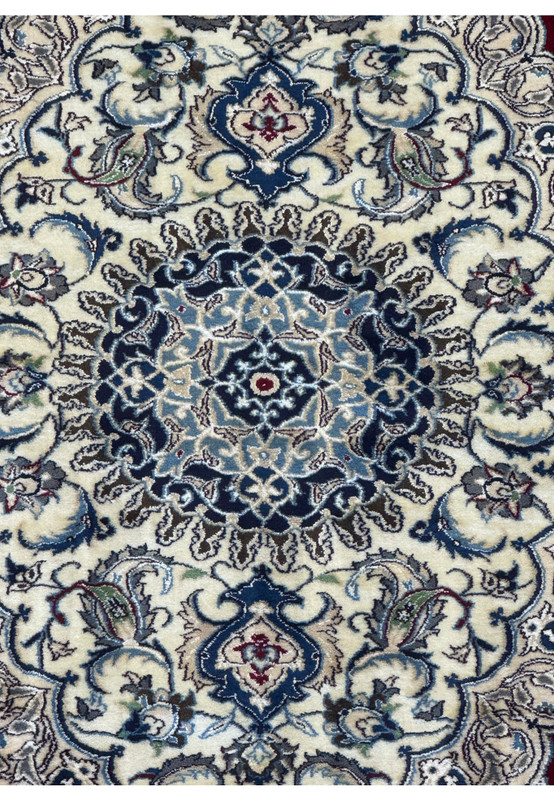 Zoomed-in view of the medallion on the 6'8 x 10'4 Persian Nain 9LAA Wool & Silk Rug, showcasing the intricate design and color details