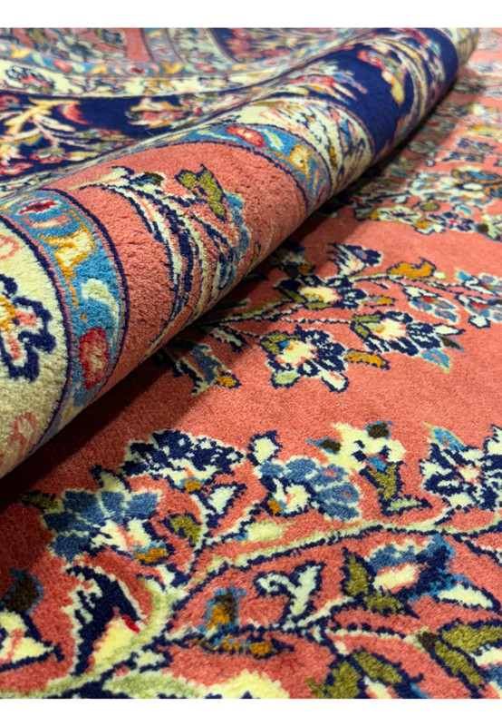 Detailed craftsmanship of floral motifs on Persian Yazd rug, highlighting natural dye colors.