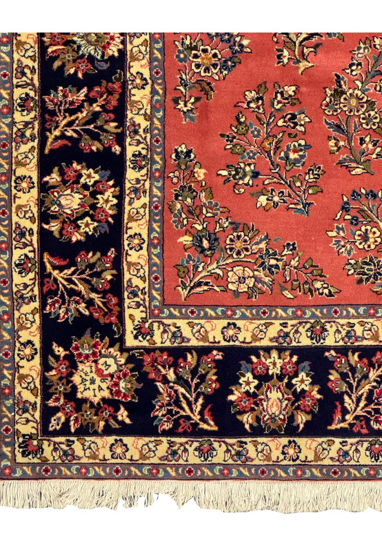 Close-up of corner design on a Persian Yazd rug, showcasing intricate vine motifs.