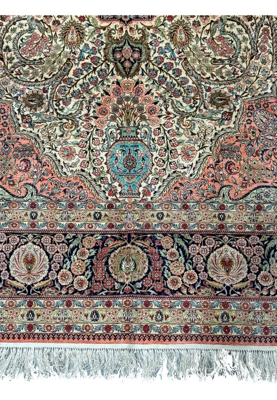 Lower section of a Persian Tabriz 100% silk rug with fringe detail.