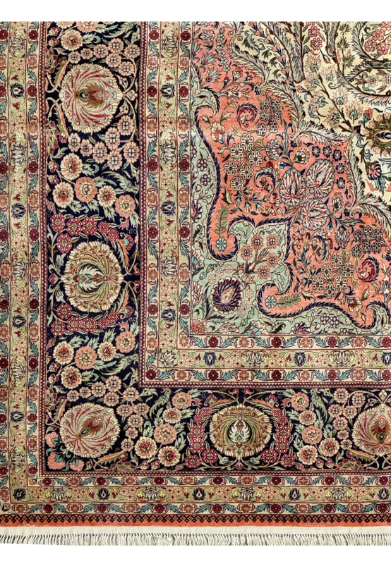 Top section of a Persian Tabriz 100% silk rug showcasing intricate floral design and fringe
