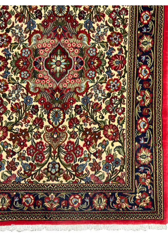 Corner section of a Persian Qum Kork rug showing intricate designs