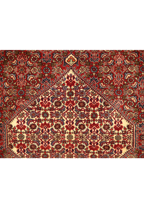Close-up of the 5'5 x 10 Persian Bijar Rug's central medallion and surrounding floral patterns in rich crimson and navy blue