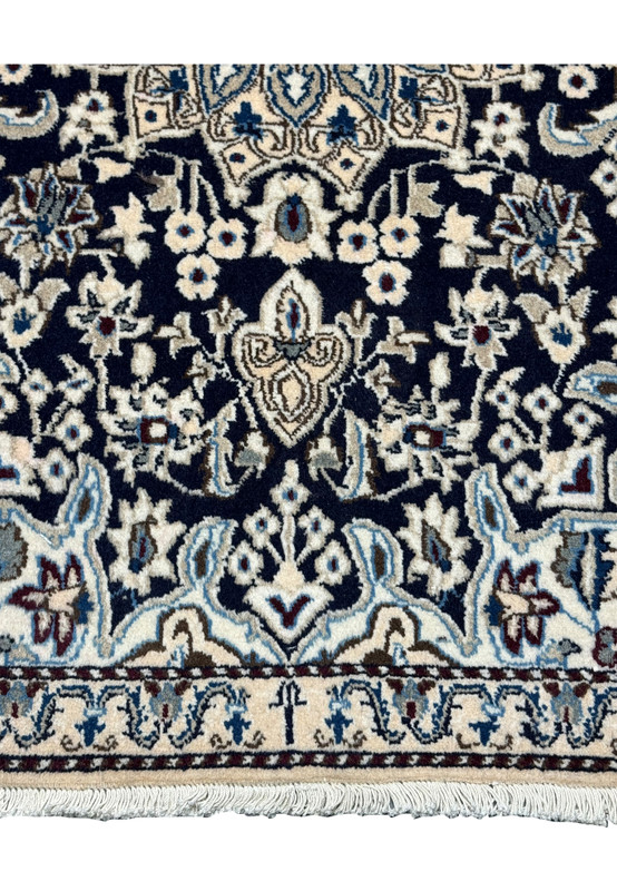 Detailed view of the lower border of the 3x5 Persian Nain rug.