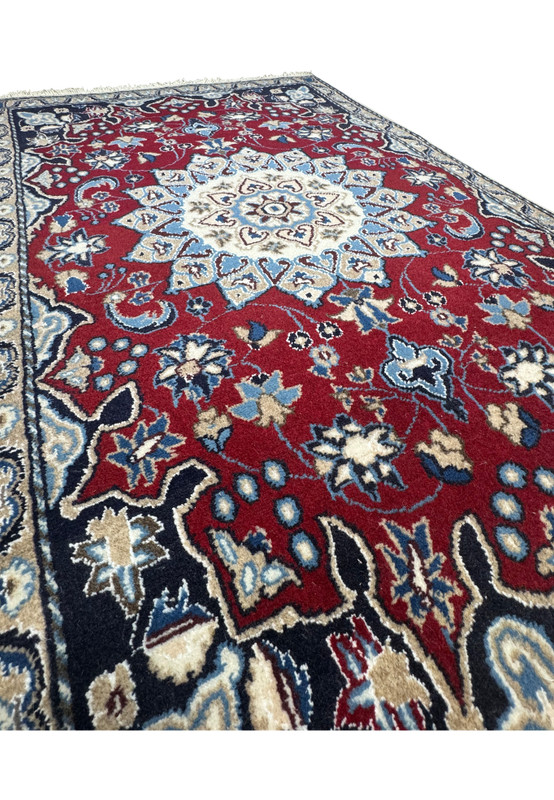 Side view of the 2'10" x 4'5" Red Persian Nain Rug, showcasing the plush texture and detailed patterns.