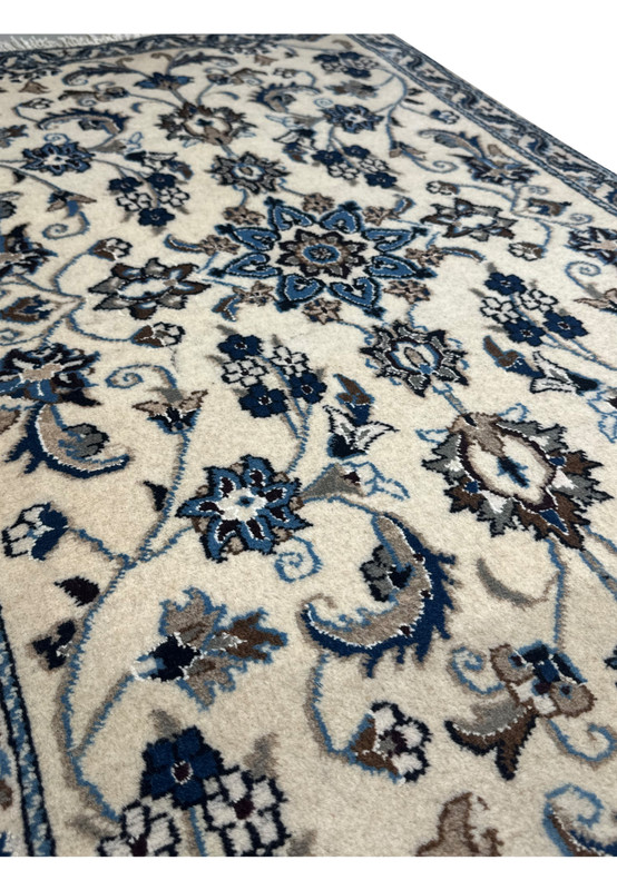 Side view of a Persian Nain Rug highlighting the detailed craftsmanship and intricate patterns.