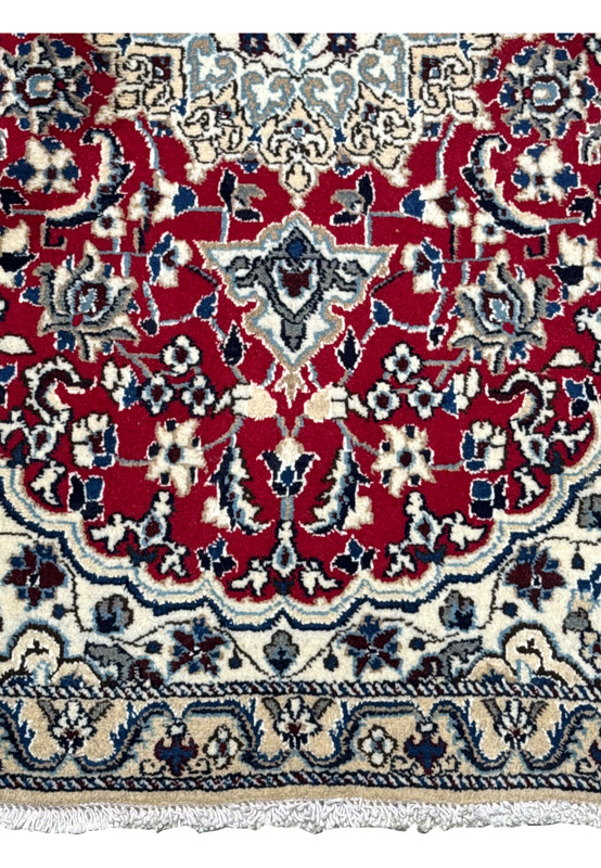 Detailed view of the lower border on a 3 x 4.6 Red Nain Persian Rug with floral and vine motifs
