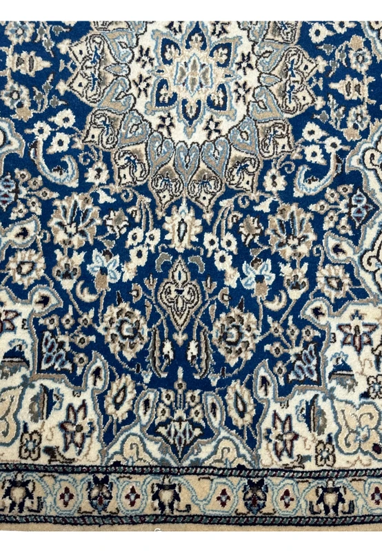 Lower border of the 3x5 Persian Nain Rug highlighting the intricate patterns and color transitions.