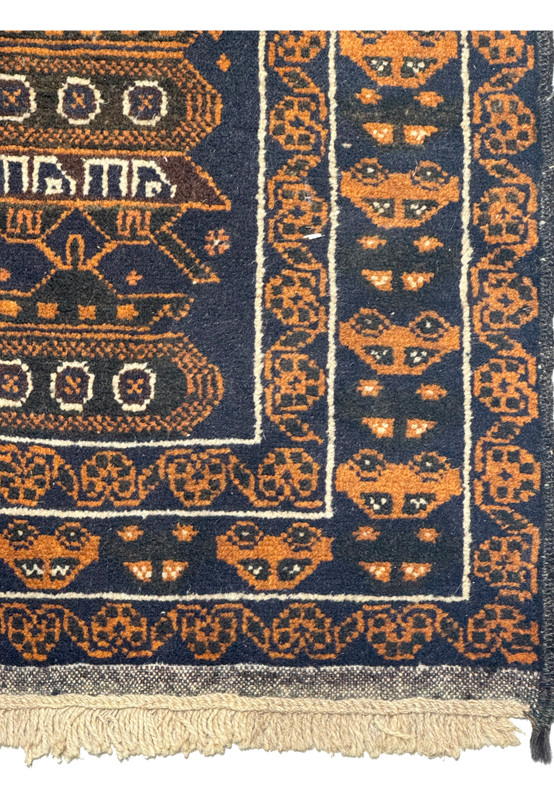 Right border of the 2'9 x 4'4 Persian Baluch Rug featuring geometric patterns and tank motifs in orange and navy.