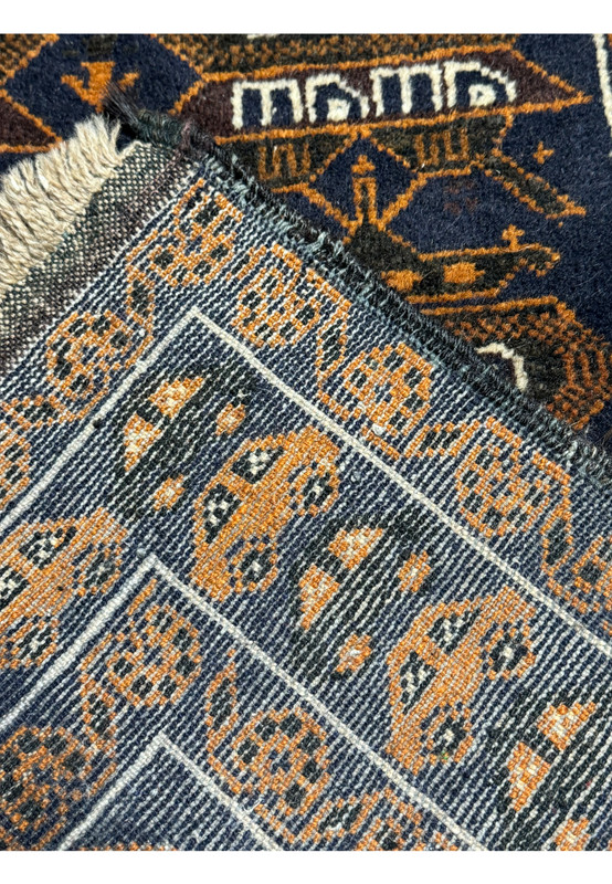 Backside of the 2'9 x 4'4 Persian Baluch Rug showing the intricate construction and detailed knotting.