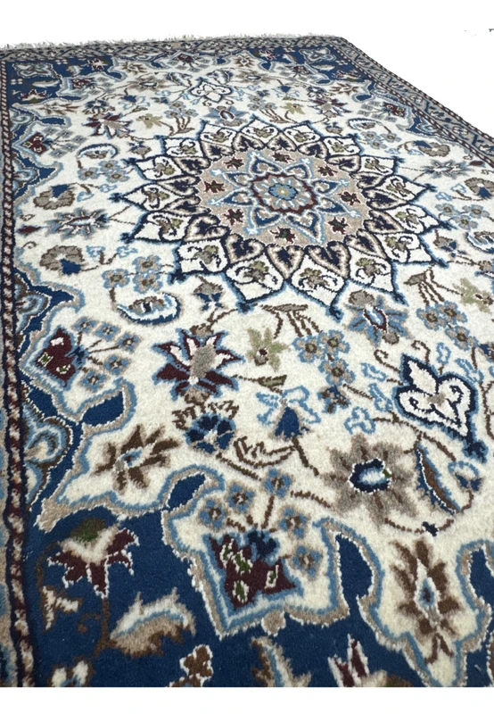 Angled view of the 3 x 4'6 Nain Persian Rug, showcasing the rug’s texture and detailed floral patterns.