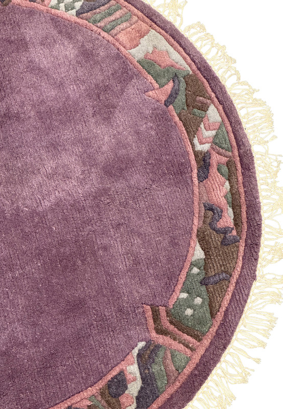 Close-up of the intricate border patterns in muted rose, olive green, and deep brown on the 4'8 x 4'8 round rug.