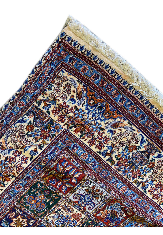 Detailed view of the edge of the Persian Moud Rug with fringe and border design.