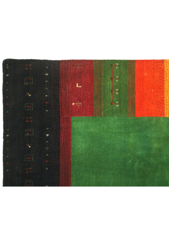 Edge of 8'3" x 9'11" Gabbeh rug highlighting the fine weaving and color transitions.
