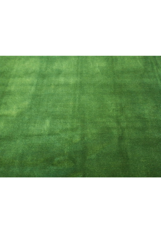 Midfield view of 8'3" x 9'11" Gabbeh rug emphasizing the solid green color.