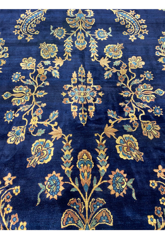 Close-up of the handwoven Persian Kerman Lavar rug showing intricate floral motifs